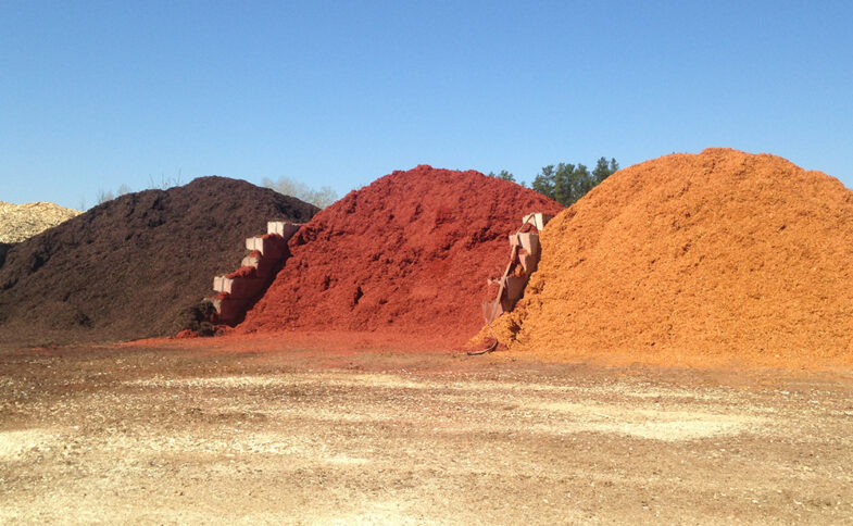Piles of mulch in three colors, at the Savanna Pallets manufacturing plant in Duluth, MN